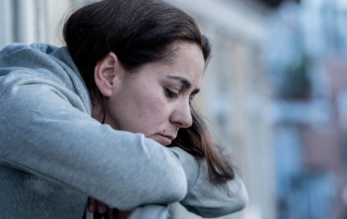 Woman peering over balcony